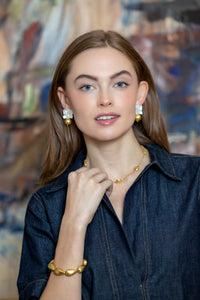 model wearing audrey mother of pearl and gold ball earrings_m donohue collection
