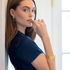 model wearing Avignon gold wicker and blue quartz gemstone earrings with gold Jardin bangle bracelet_m donohue collection