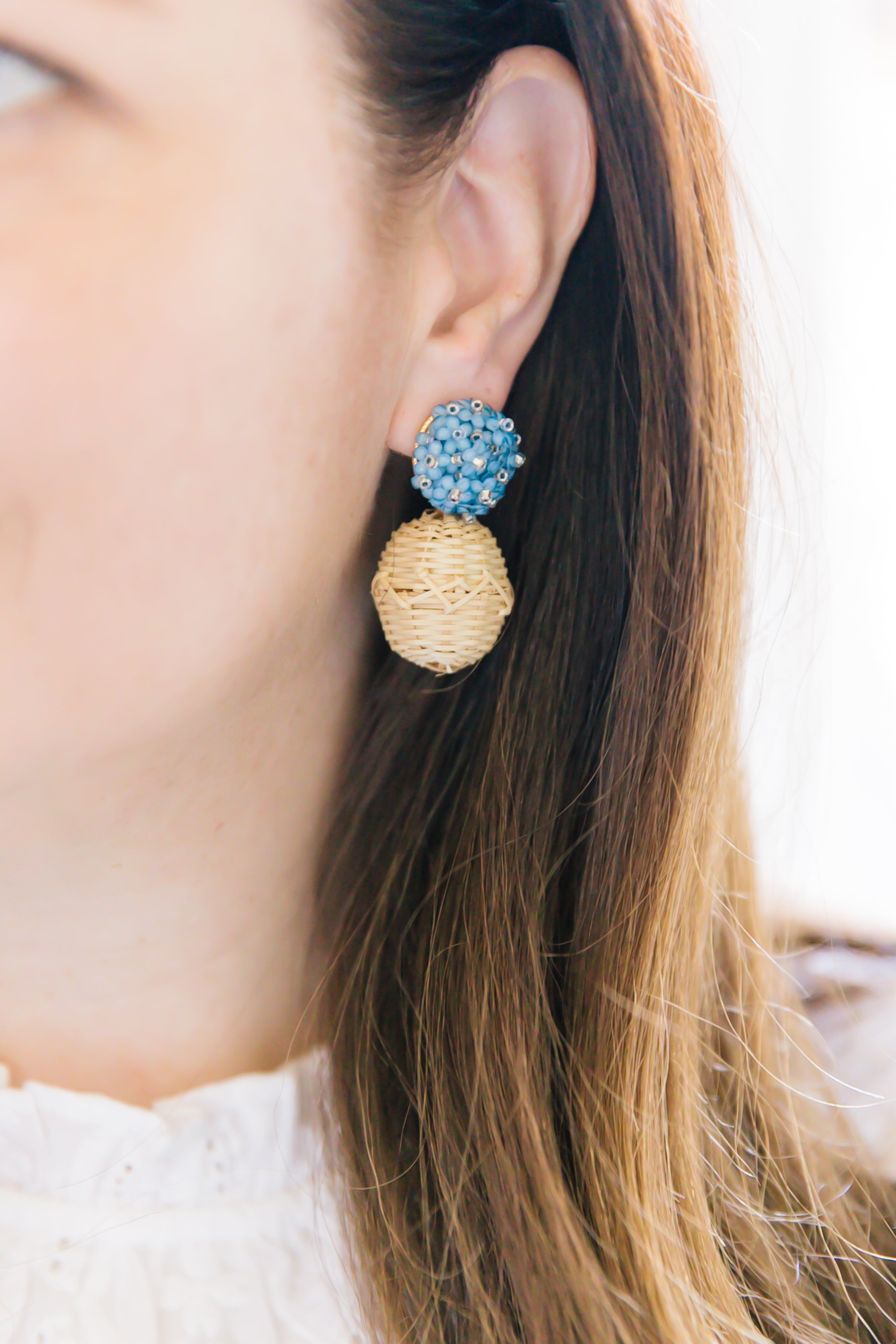 Model is wearing Liz Blue Rattan Ball Earrings_m donohue collection