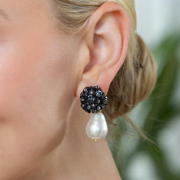 model wearing black onyx flower earrings with teardrop cotton pearl_m donohue collection