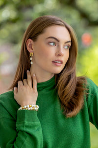 model wearing gold post earrings with double pearl drops_ m donohue collection