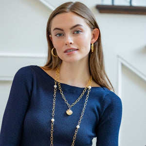 Model is wearing Maison Treillage Gold Hoop Earrings_m donohue collection