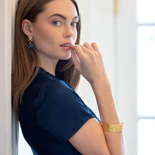 Load image into Gallery viewer, model wearing Avignon gold wicker and blue quartz gemstone earrings with gold Jardin bangle bracelet_m donohue collection