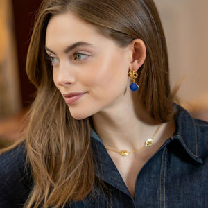 model wearing gold wicker Avignon post with cobalt blue gemestones_m donohue collection