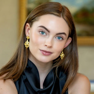 Model wears the gold floral Bloom Floral Cluster earrings_m donohue collection