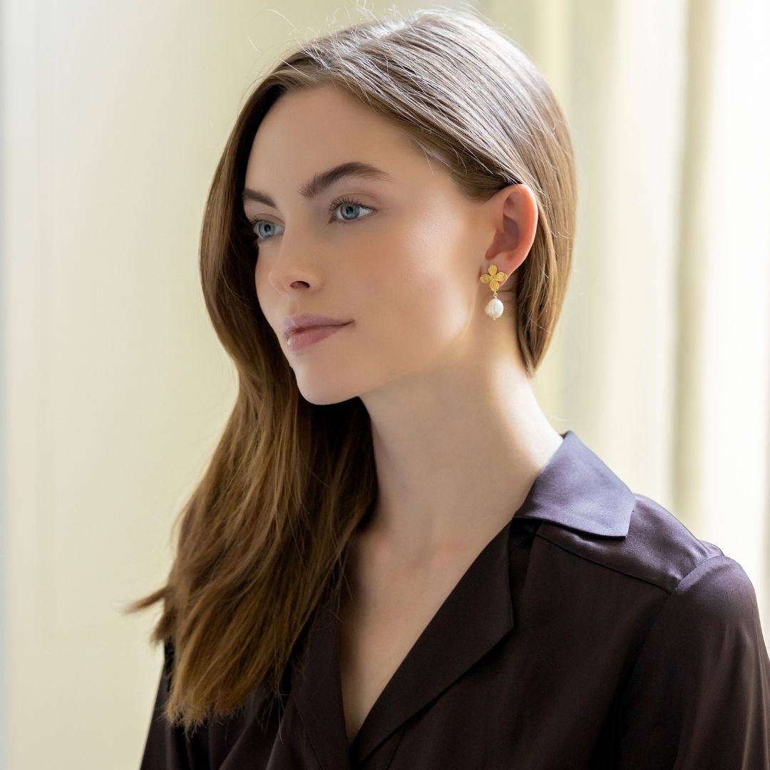 Model wears the gold floral Bloom Pearl Drop Earring_m donohue collection