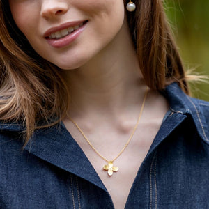 Model wears gold flower Bloom Single Flower necklace_m donohue collection