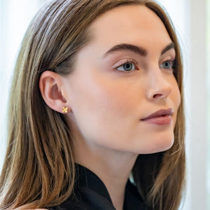 Model is wearing Tiny Bloom Gold Stud Earrings_m donohue collection
