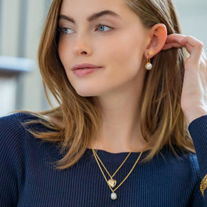 Model is wearing Tiny Bloom Pearl Stud Earrings_m donohue collection