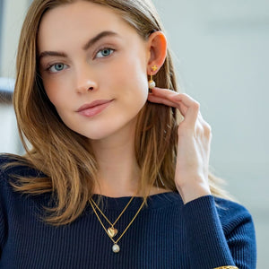 Model is wearing Tiny Bloom Pearl Stud Earrings_m donohue collection