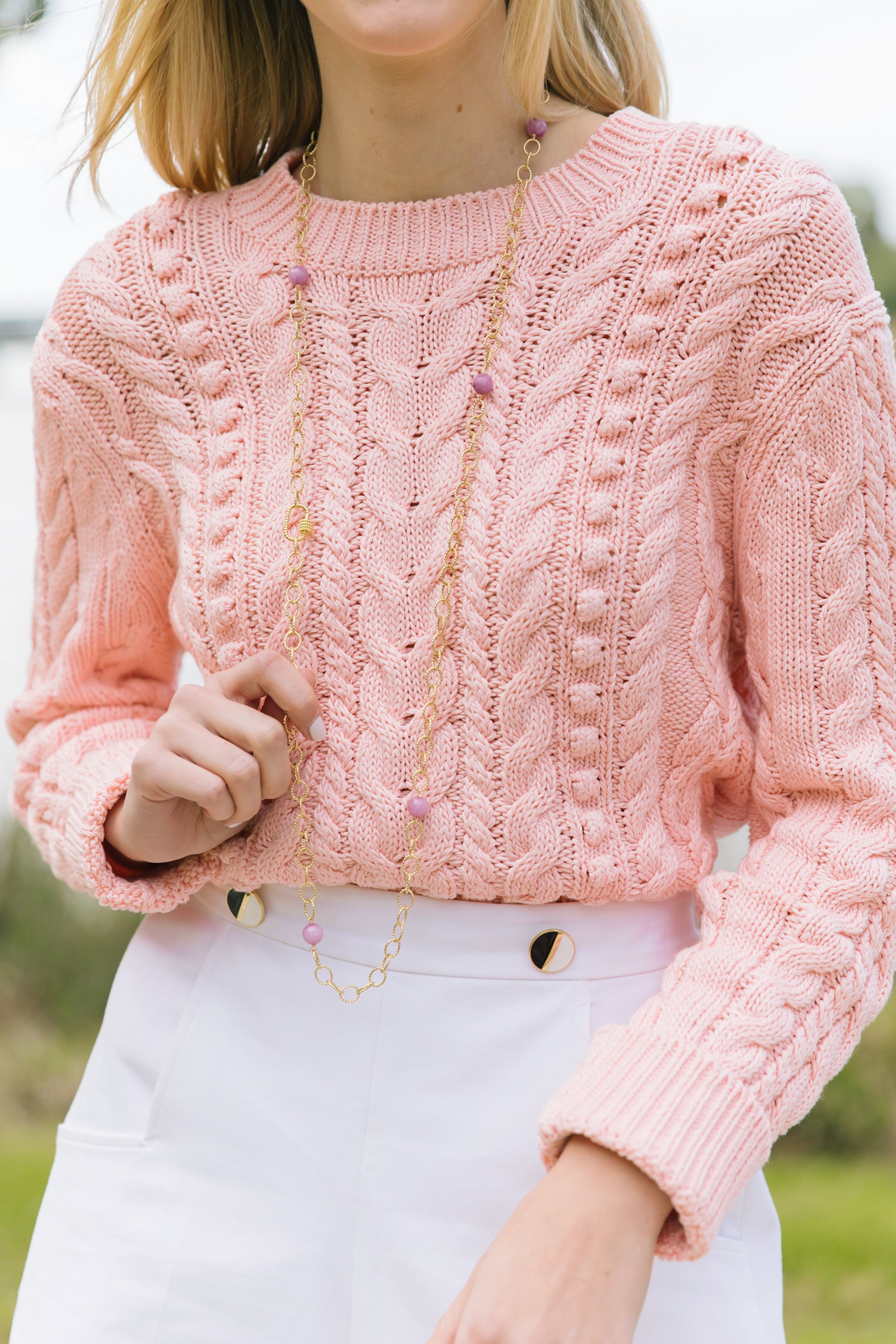 Model wears long Annabelle Gold and Lilac gemstone necklace with sweater_m donohue collection