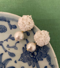 Load image into Gallery viewer, Liz Cotton Pearl White Earrings displayed on blue porcelain_m donohue collection