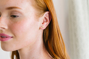 Model is wearing Tiny Bloom Gold Stud Earrings_m donohue collection