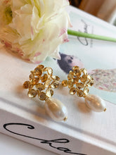 Load image into Gallery viewer, Sara Gold White Pearl Earrings displayed with white florals_m donohue collection