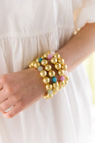 Model is wearing Pamela Gold & Lilac Bracelet with Pamela Sage, Aqua, and Rose Bracelets_m donohue collection